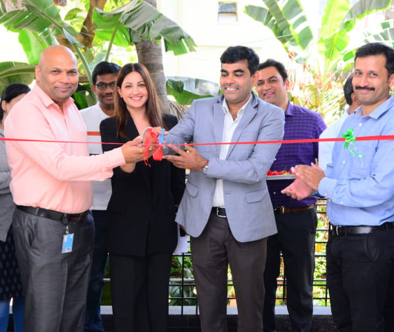 Cutting ribbon at Bangalore office ceremony